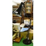 A black angle poise lamp.