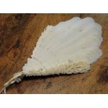 A carved ivory fan with feather design screen.