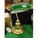 An adjustable desk lamp with green shade.