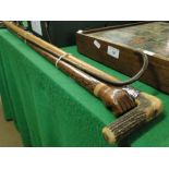 A Malacca cane with silver collar, a stick with a carved fist end and a child's walking stick.