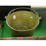 A brass preserve pan with swing handle.