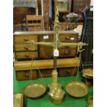 A brass shop balance scale with weights.