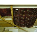 A small red ground Persian mat and a red ground Afghan rug.