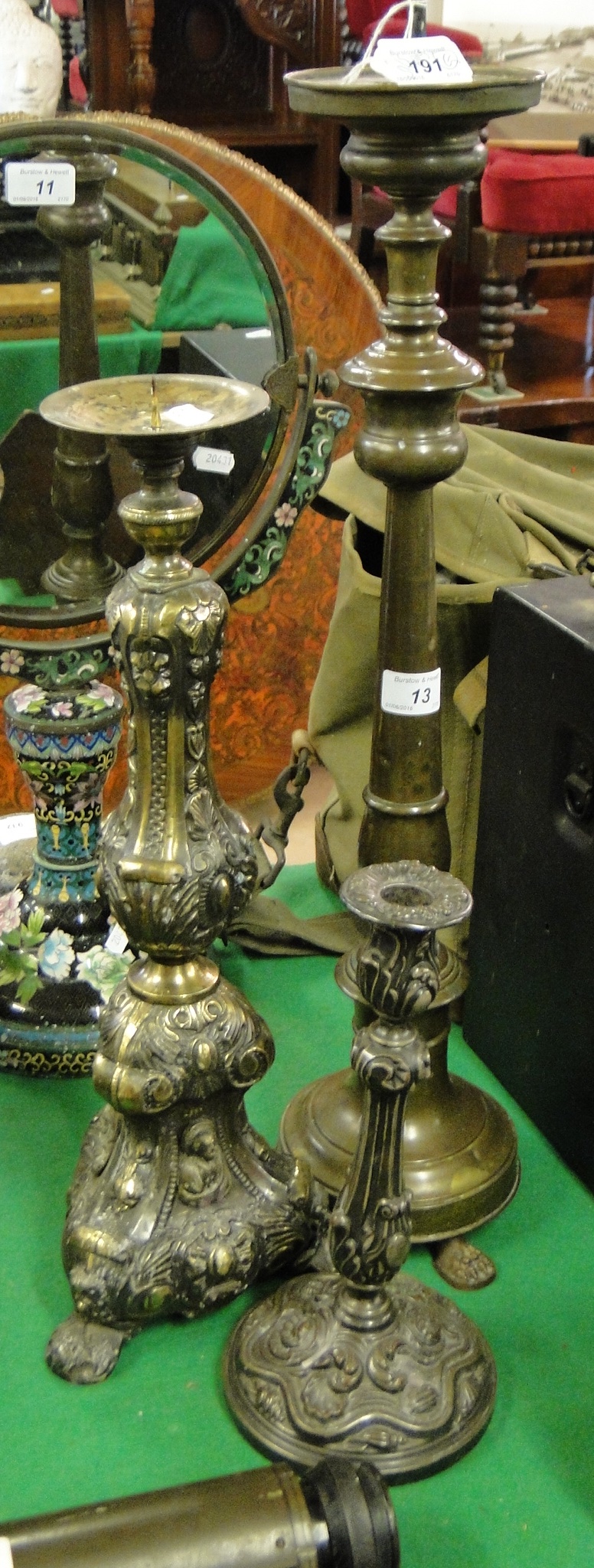 A brass pricket candlestick, height 26", and 2 embossed candlesticks, (3).