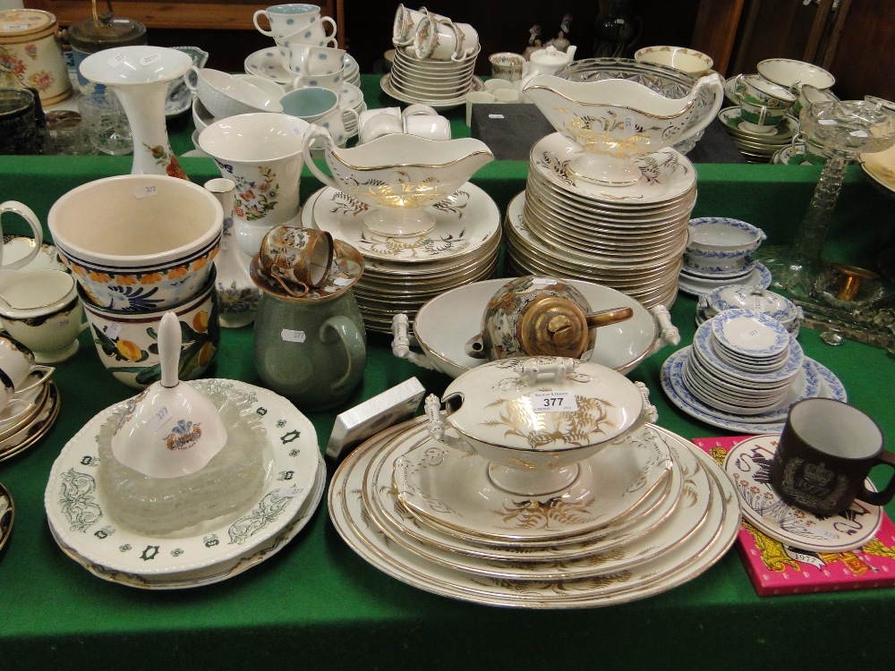 An extensive white and gold decorated dinner service including tureens and meat plates,