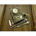 A silver fronted desk clock, silver handled button hook, glove stretcher, etc.