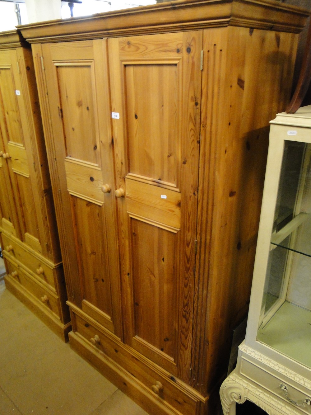 A modern panelled pine 2-door wardrobe with drawer fitted base.