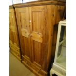 A modern panelled pine 2-door wardrobe with drawer fitted base.