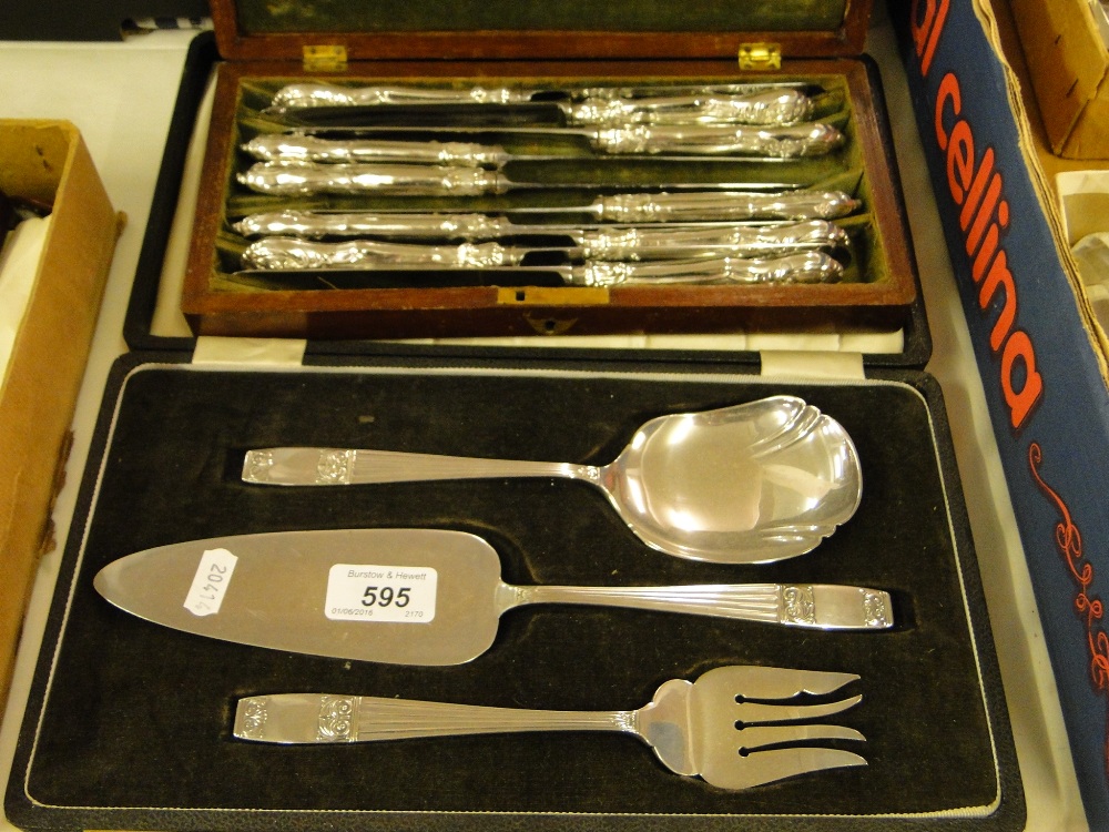 An Elkington plate 3-piece cased serving set, and a cased set of 10 silver handled dinner knives.