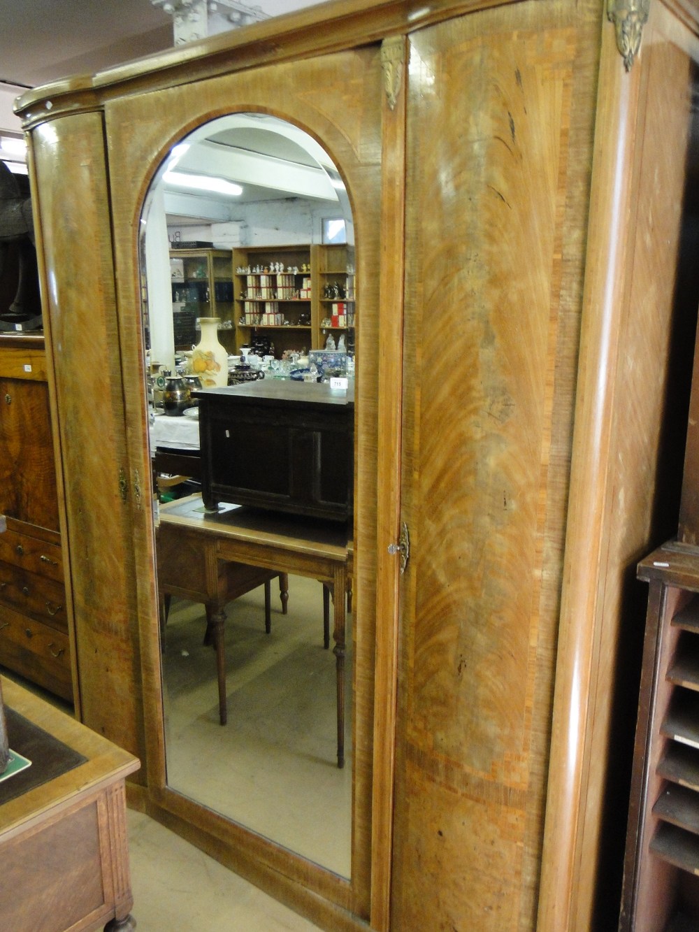 A continental crossbanded walnut armoire, with single mirror door, ormolu mounts.