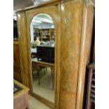 A continental crossbanded walnut armoire, with single mirror door, ormolu mounts.