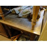 An oak plank top kitchen table with end frieze drawer and turned legs.