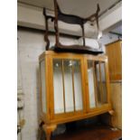 An oak bow front 2-door display cabinet and an Edwardian occasional table.