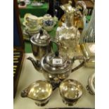 A silver plated and embossed wine ewer and a 4-piece plated teaset.