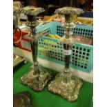 Pair of ornate embossed silver plated candlesticks.