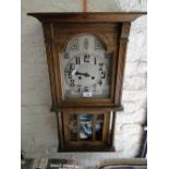 An oak cased 2-train wall clock.