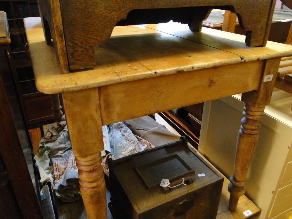 An Antique pine kitchen table on turned baluster legs.