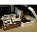 A leather suitcase containing a quantity of hardback reference books and a suitcase of material,