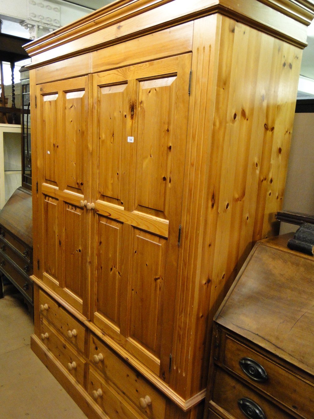 A modern panelled pine 2-door wardrobe with drawer fitted base.