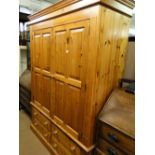 A modern panelled pine 2-door wardrobe with drawer fitted base.