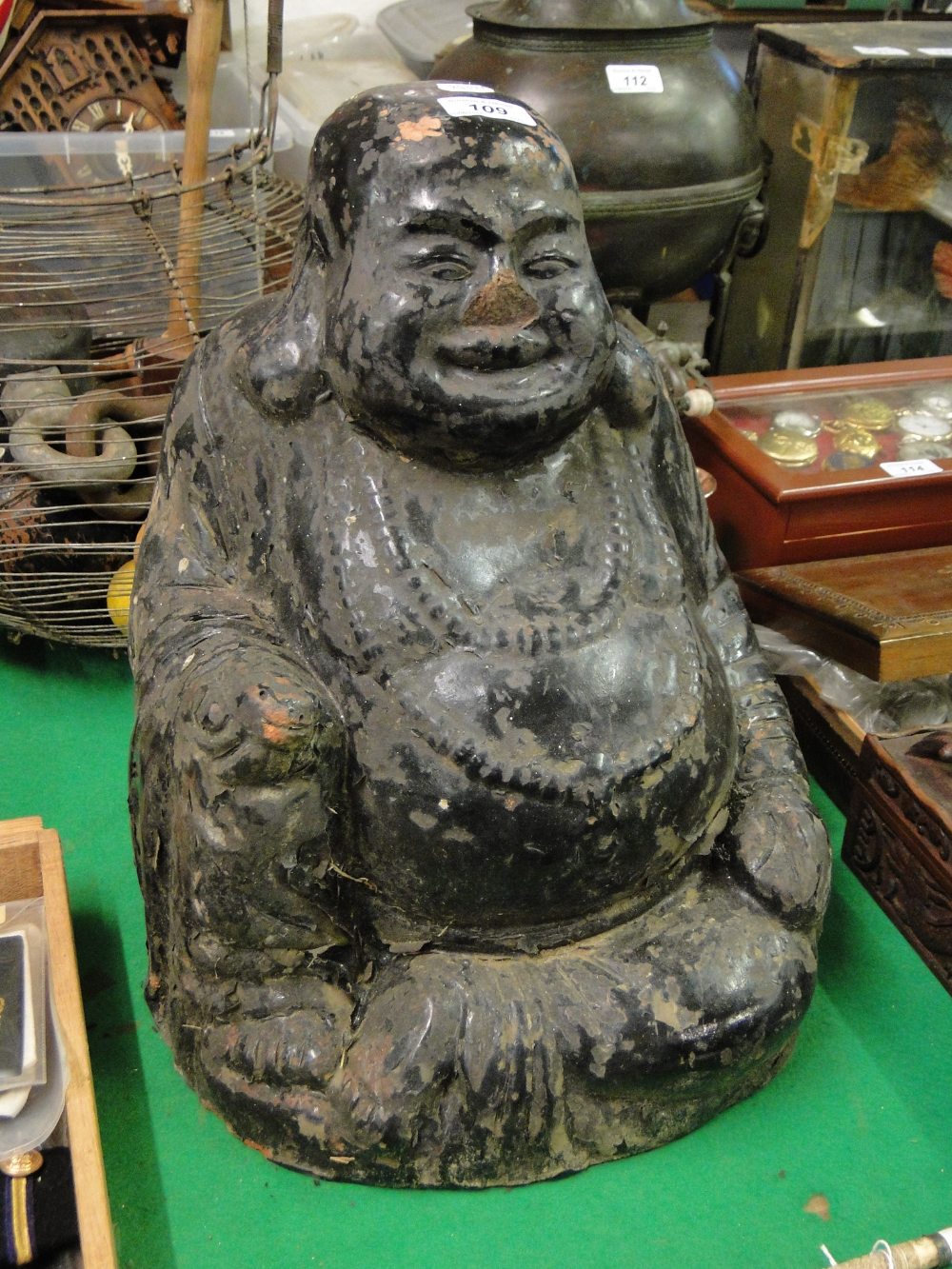 A large Chinese carved and painted terrocotta seated Buddha, height 15".