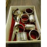 6 various silver napkin rings, 2 silver peppers, silver berry spoon,