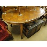 A French parquetry topped oak oval dining table on cabriole legs.