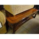 A large rectangular mahogany coffee table with 6 short drawers.