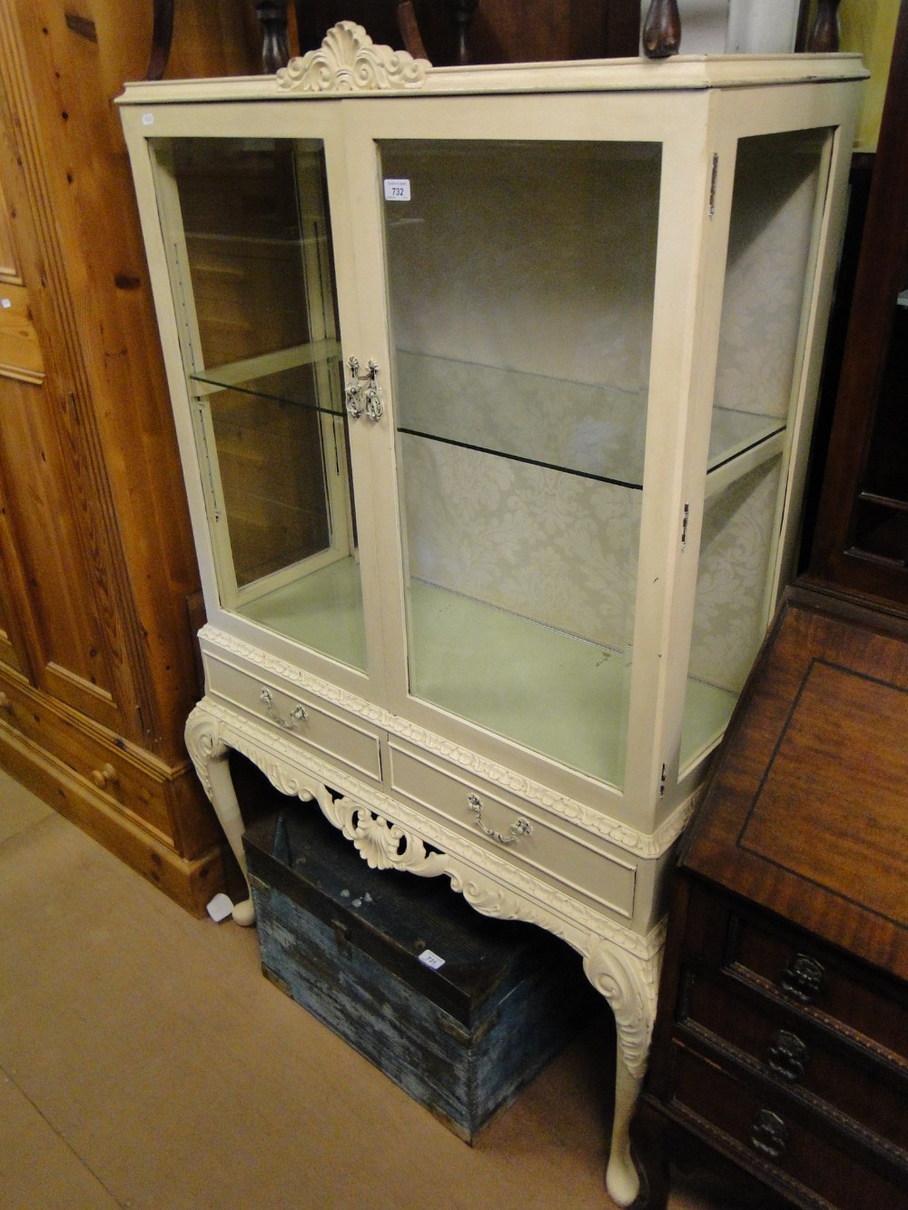 A painted 2-door display cabinet on stand.