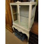 A painted 2-door display cabinet on stand.
