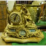 An ornate continental gilt metal cased mantel clock surmounted by a shepherd boy.