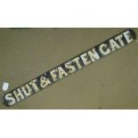 An Antique cast-iron railway sign "Shut & Fasten Gate," length 32".