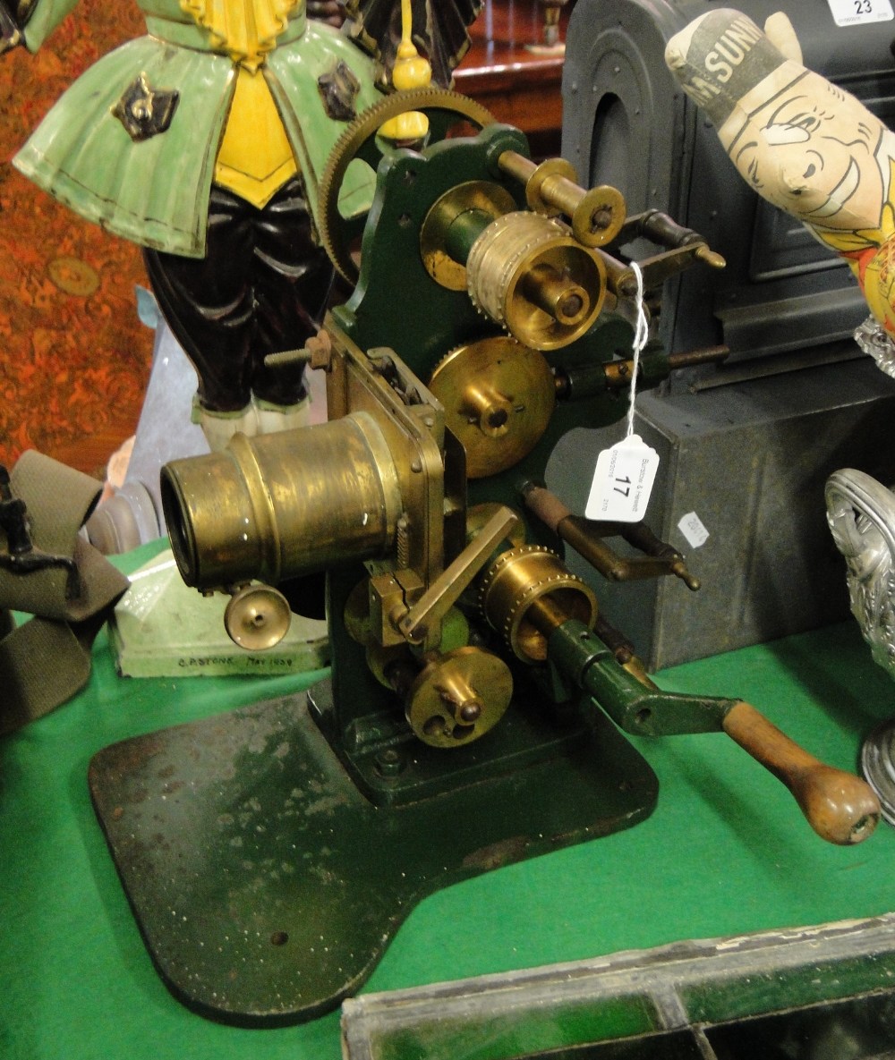 An unusual Antique cast-iron framed 35mm film projector, with brass lenses and brass wheels,