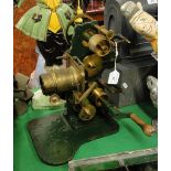 An unusual Antique cast-iron framed 35mm film projector, with brass lenses and brass wheels,