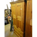 A modern panelled pine 2-door wardrobe with 2 drawers to the base.