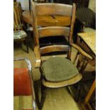 A Victorian elm seated ladder back kitchen elbow chair.