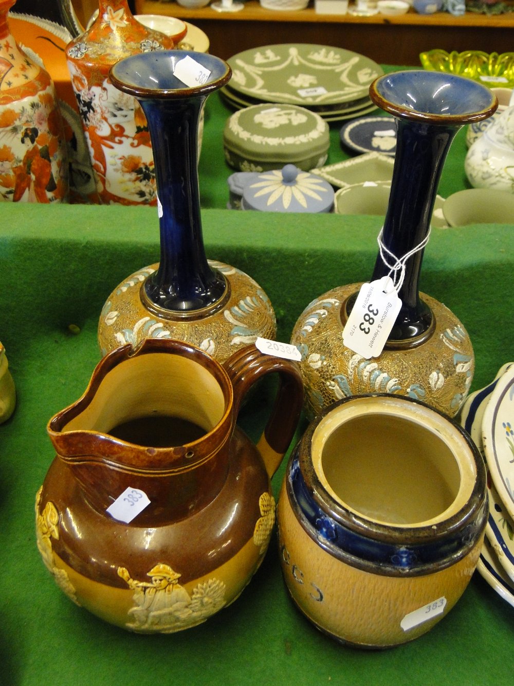 Pair of Royal Doulton long neck vases, a Doulton Harvest jug and tobacco jar.