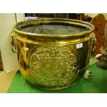 A 19th century brass log bin with embossed Coat of Arms.