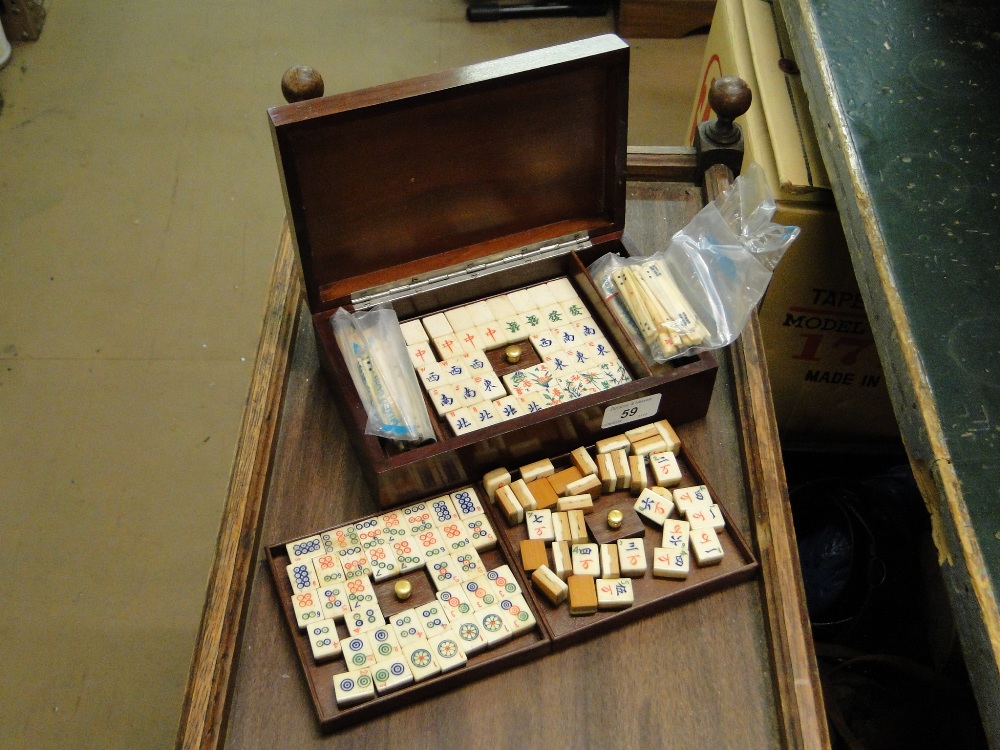 A Chinese miniature bone and bamboo Mah-Jong set in mahogany case.