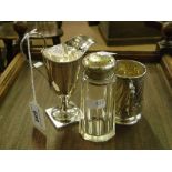A silver Christening mug, silver cream jug and a silver sifter.