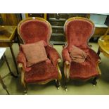 Pair of Victorian button back upholstered armchairs with carved mahogany showwood.