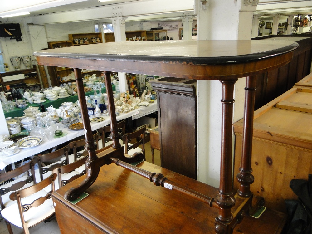 A Victorian figured walnut stretcher table.
