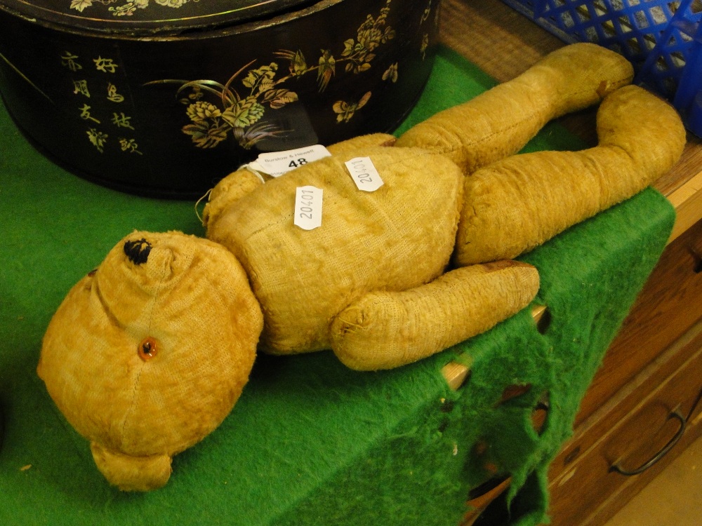 An Antique straw filled teddybear, height 14".