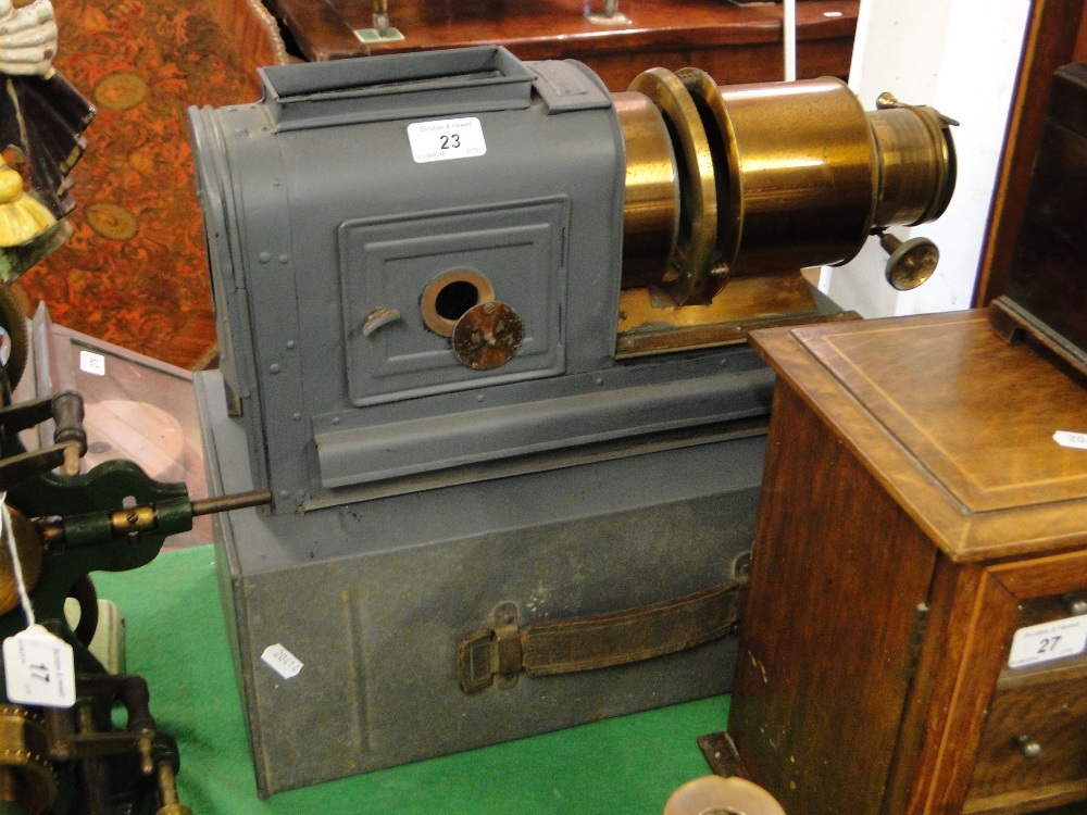 A painted tinplate magic lantern with brass lenses.