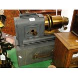 A painted tinplate magic lantern with brass lenses.