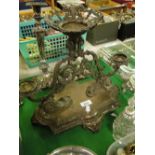 A Victorian silver plated 3 branch table centre supported by lions.