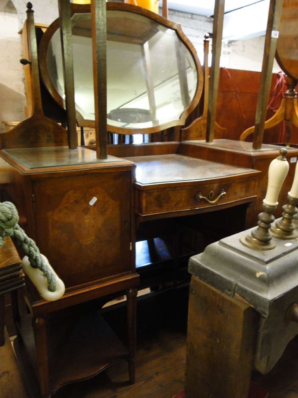A walnut drop centre dressing table, being of crossbanded form with marquetry decoration.