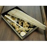 A box of ivory and bone items including Chinese carved figures, a carved and pierced bone fan, etc.