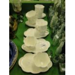 A set of 7 Shelley "Dainty" white porcelain tea and toast cups on shaped saucers.