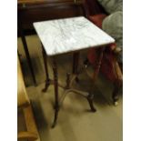 An Edwardian marble top occasional table with turned legs.